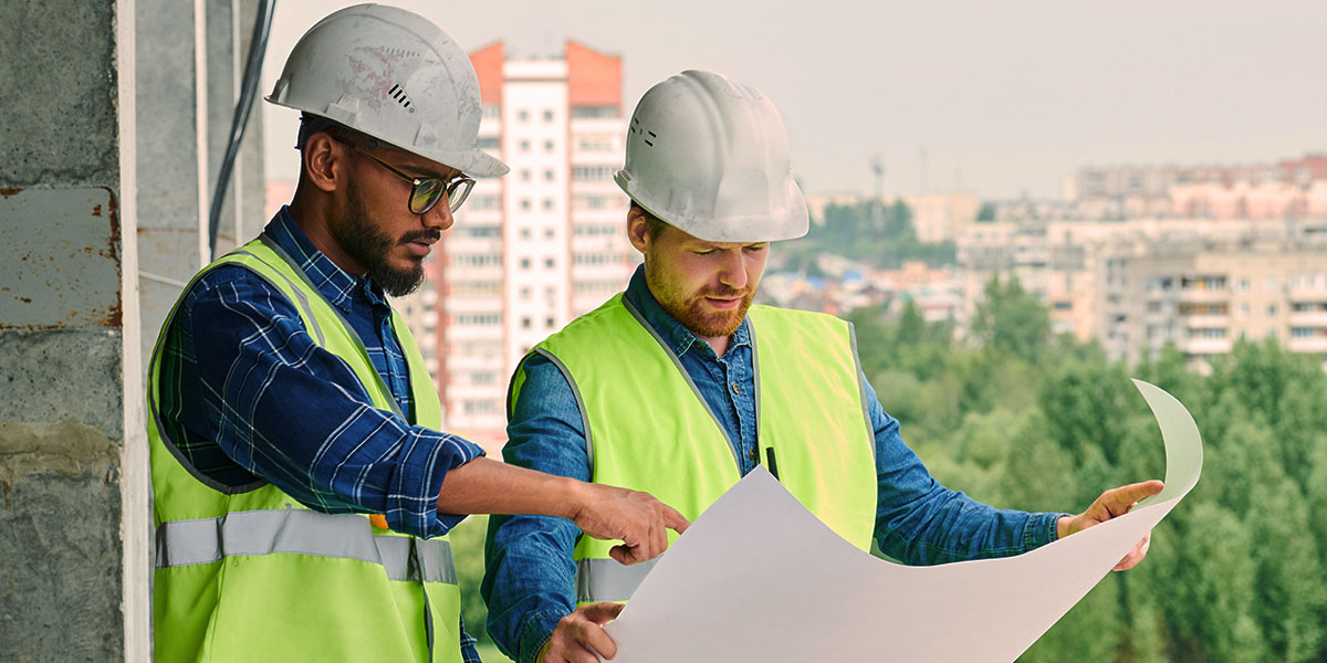 Project manager and foreman team reviewing document representing change order requests in the construction industry